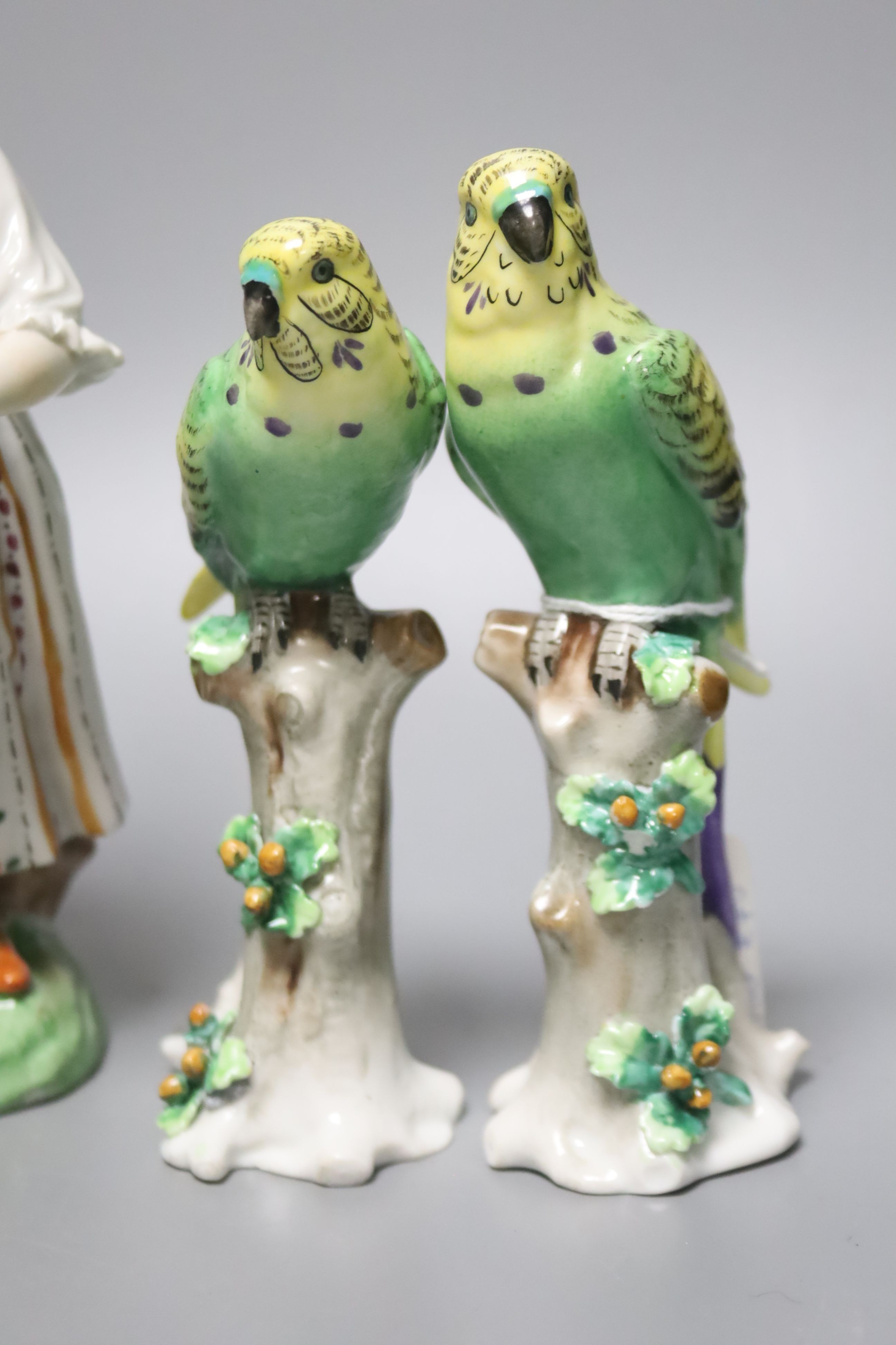 Three Continental figures and a collection of bird ornaments, tallest 22cm